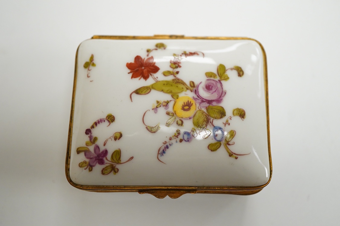 Three early 20th century French porcelain snuff boxes with floral decoration, 7cm wide